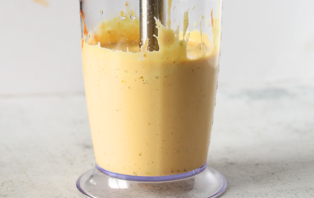 Once some of the oil has been incorporated, slowly tilt and lift the blender to incorporate the rest of the oil until no oil remains.