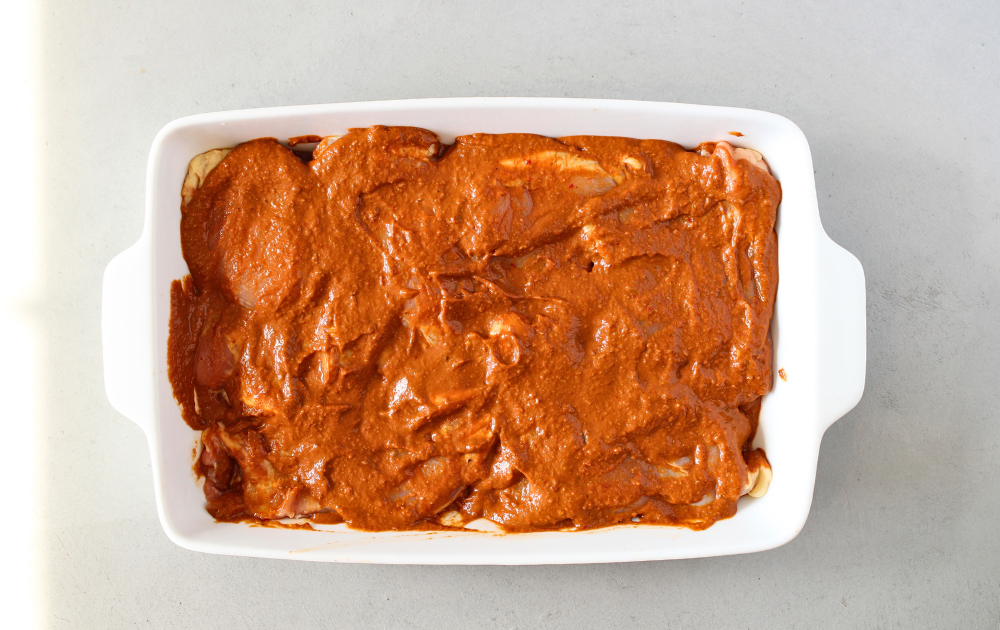 Adjust the oven rack to the middle position and heat the oven to 400 degrees. Arrange chicken in a single layer in a shallow baking dish and cover with mole sauce
