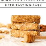 3 homemade keto fasting bars in honey nut flavour with a honey stick in front