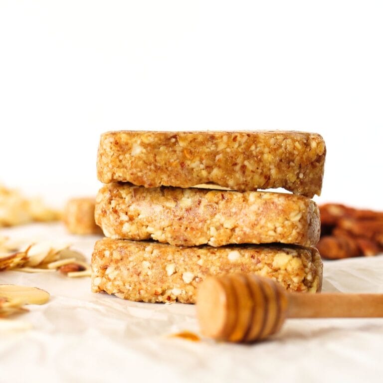 front view of 3 stacked homemade keto fasting bars wtih a honey stir stick