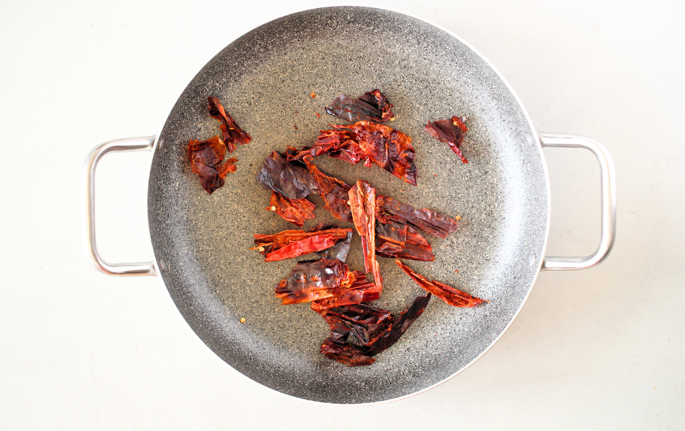 brown the dried ancho chile until they begin to brown