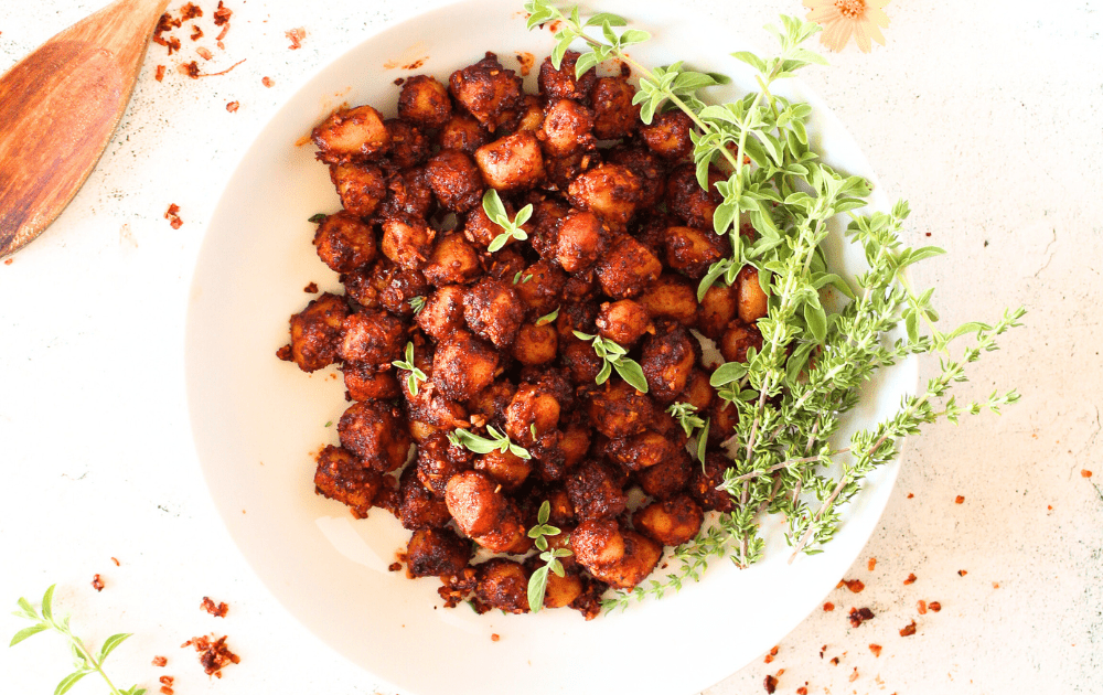 top view of a bowl filled with air fryer spicy bay scallops with herbs and spices