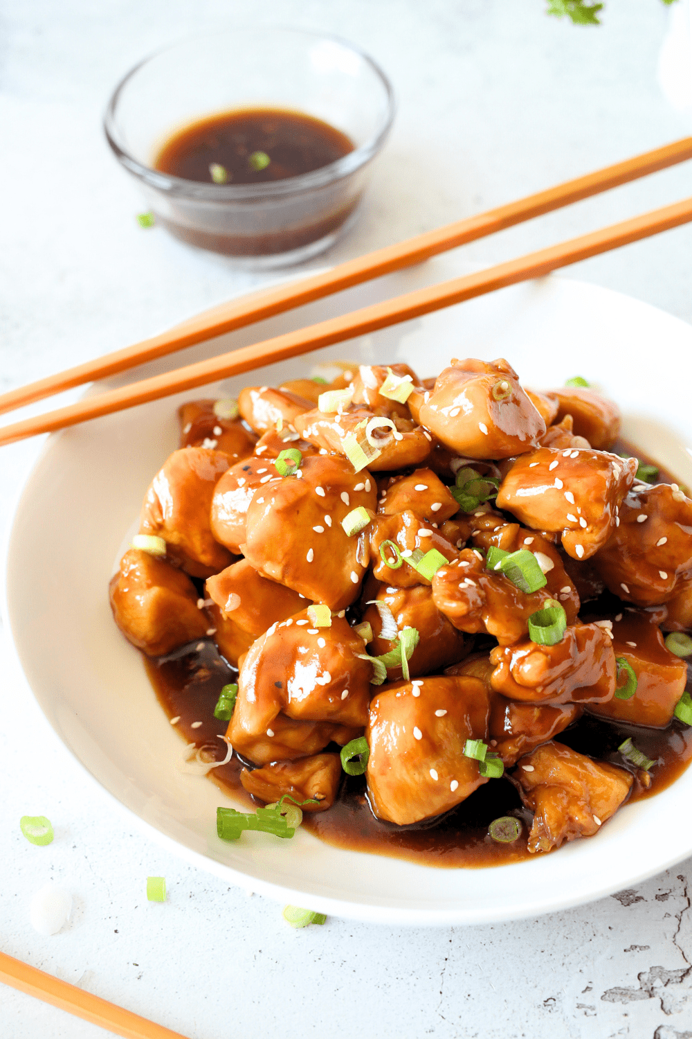 a white bowl filled with an easy keto 15-minute chicken dinner recipe made with sugar-free sweet and sour sauce.
