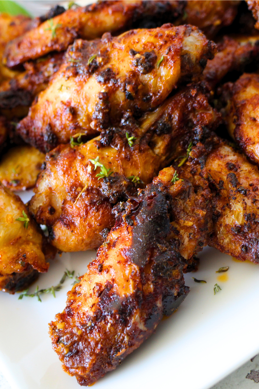 a close up view of crispy air fryer baked wings that have been tossed in a ranch dry rub.