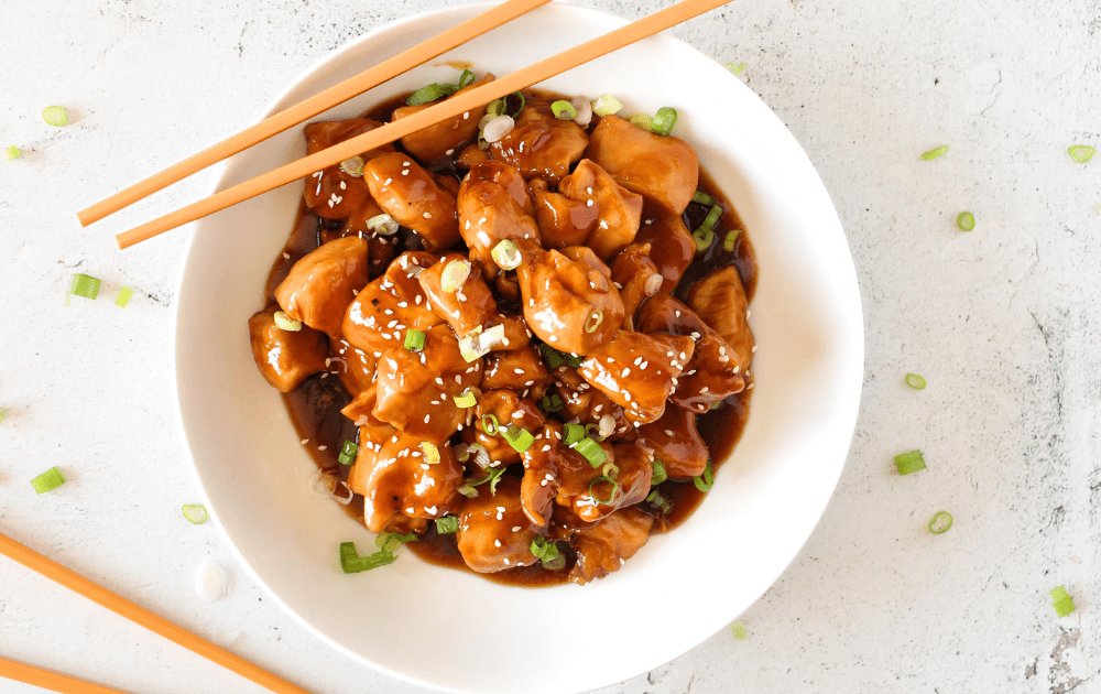 top view of a copycat keto Chinese restaurant recipe that involves chicken and sweet and sour sauce.  Chopsticks are resting on the bowl