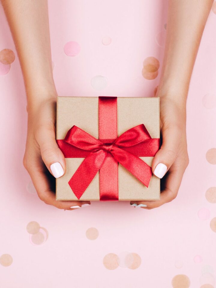 wo hands holding a present representing the best gift ideas for healthy people