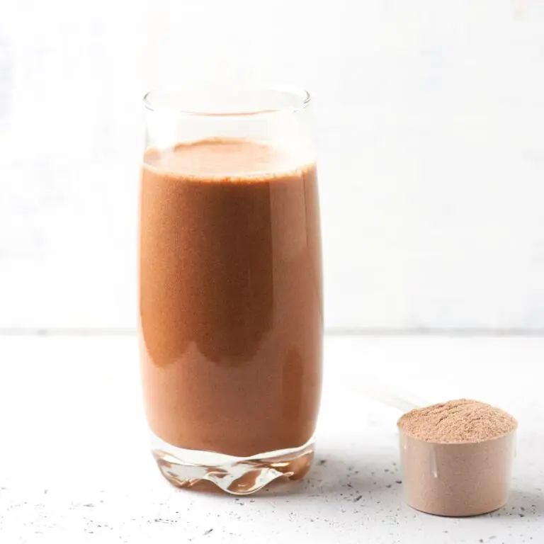 chocolate keto thick protein shake with a scoop of keto protein powder to the side
