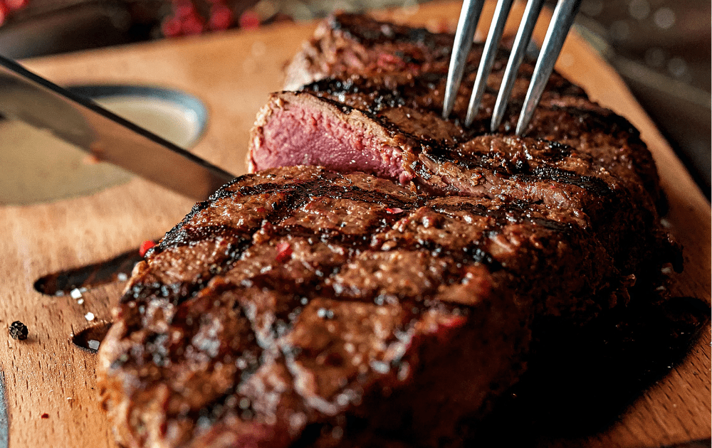 picture of a steak with a knife which is an example of a carnivore diet