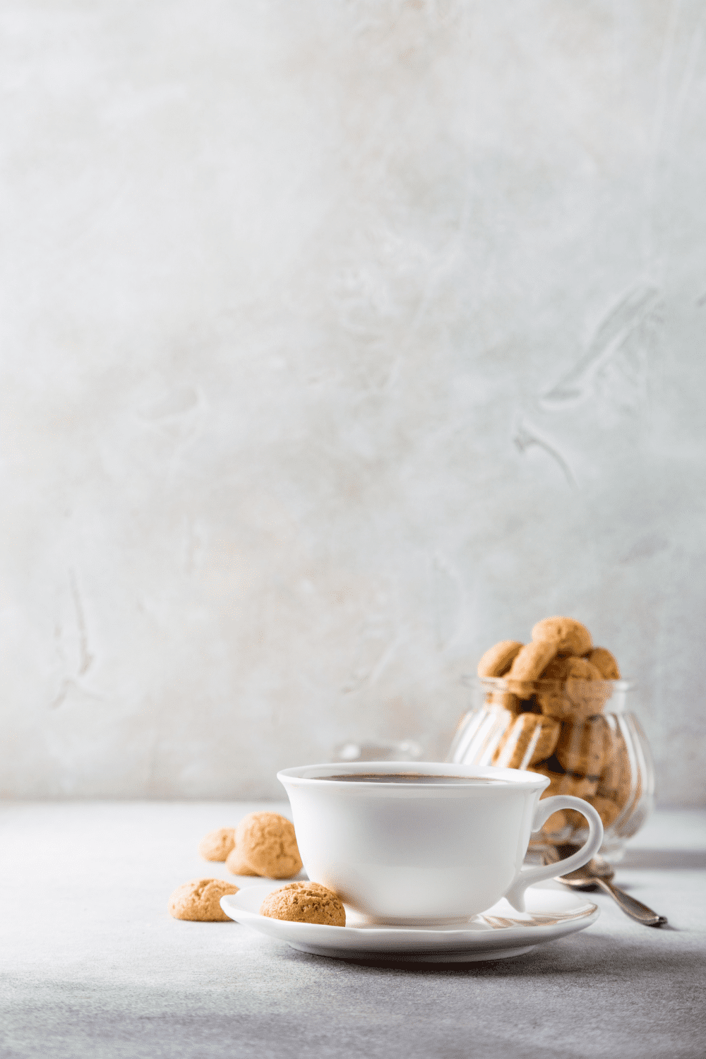 a cup of keto coffee served with keto almond flour cookies that are made with egg whites