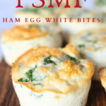 front view of a PSMF Ham Egg White Bite muffin with some spinach on a wood cutting board