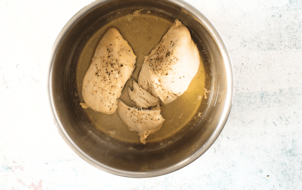 top view of a pressure cooker bowl with keto pulled chicken after being cooked
