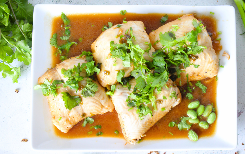 high protein fish served on a platter with ginger soy sauce and cilantro