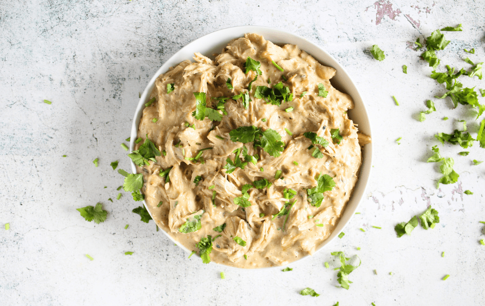 top view of a bowl of keto salsa verde chicken with fresh parsley as garnish.