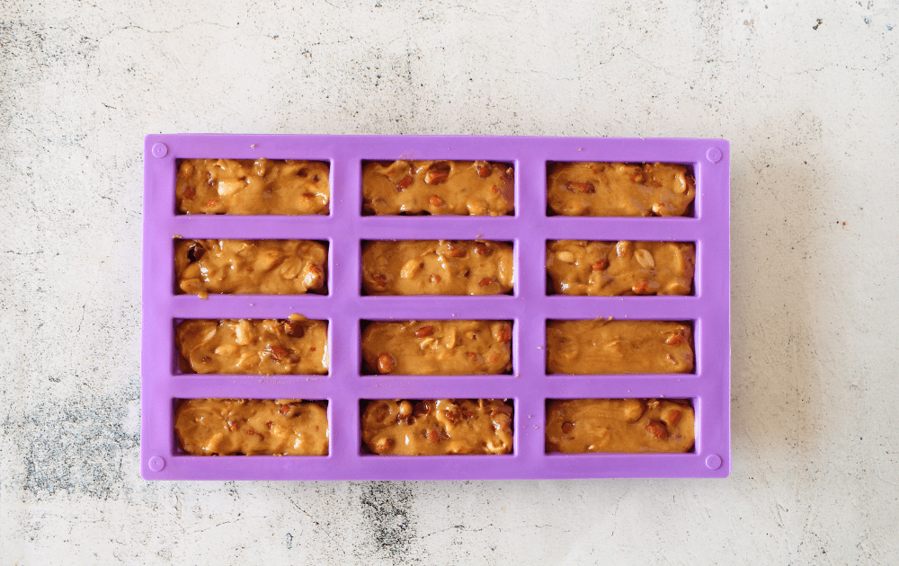 keto protein bar second layer with peanut butter, syrup and peanuts