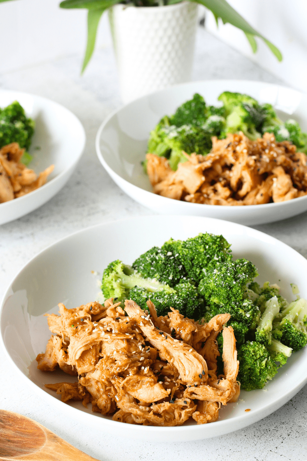 3 bowls of slow cooker chicken tossed in a PSMF sweet and spicy sauce with a side of brocolli