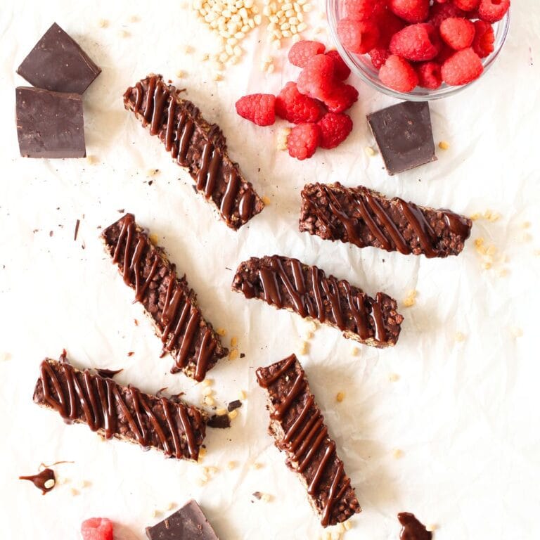 top view of copycat Keto Crunch Bars with raspberries and chocolate scattered