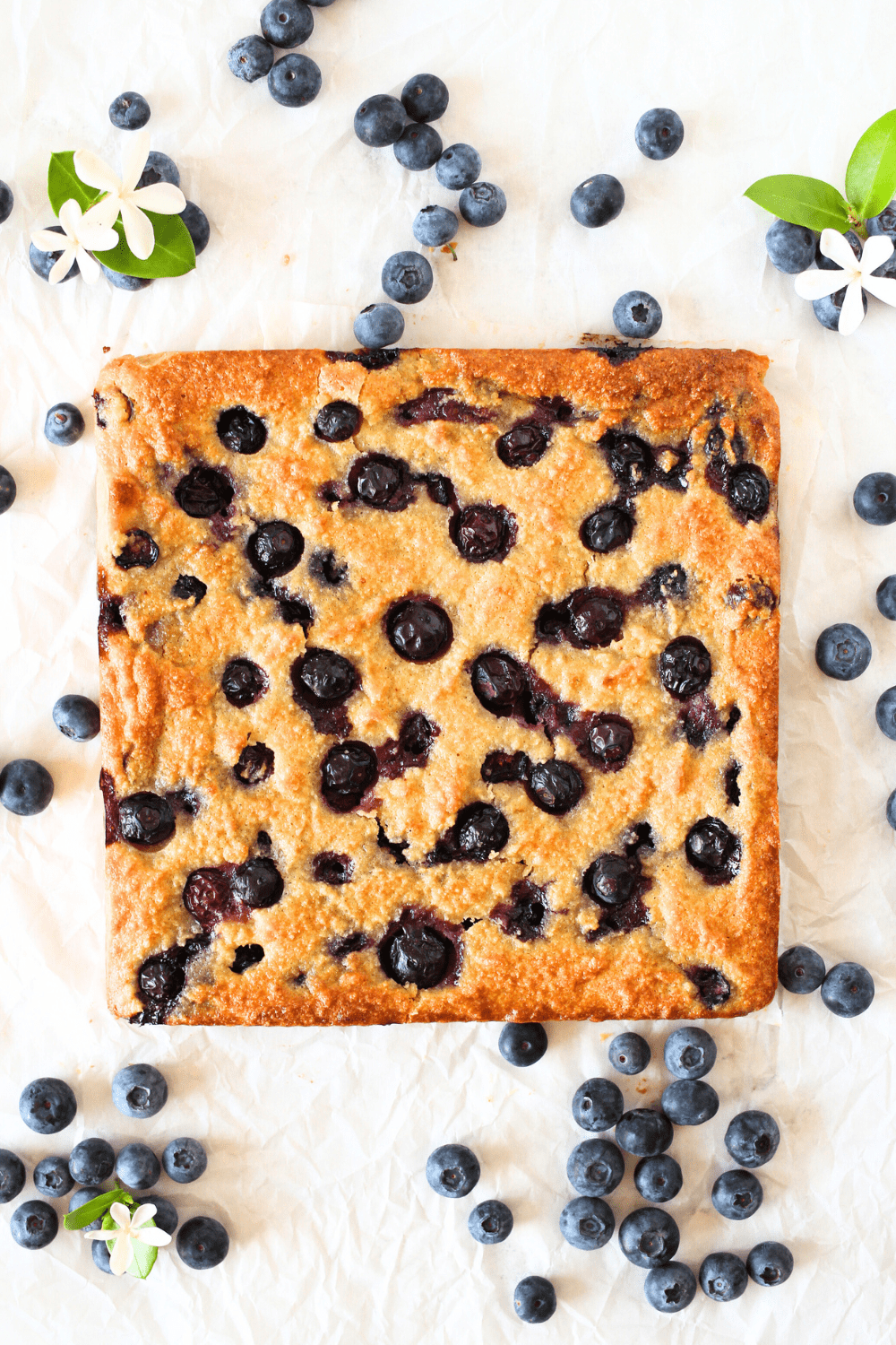 sugar-free blueberry blondies after being baked with fresh blueberries scattered around the keto blondie bars
