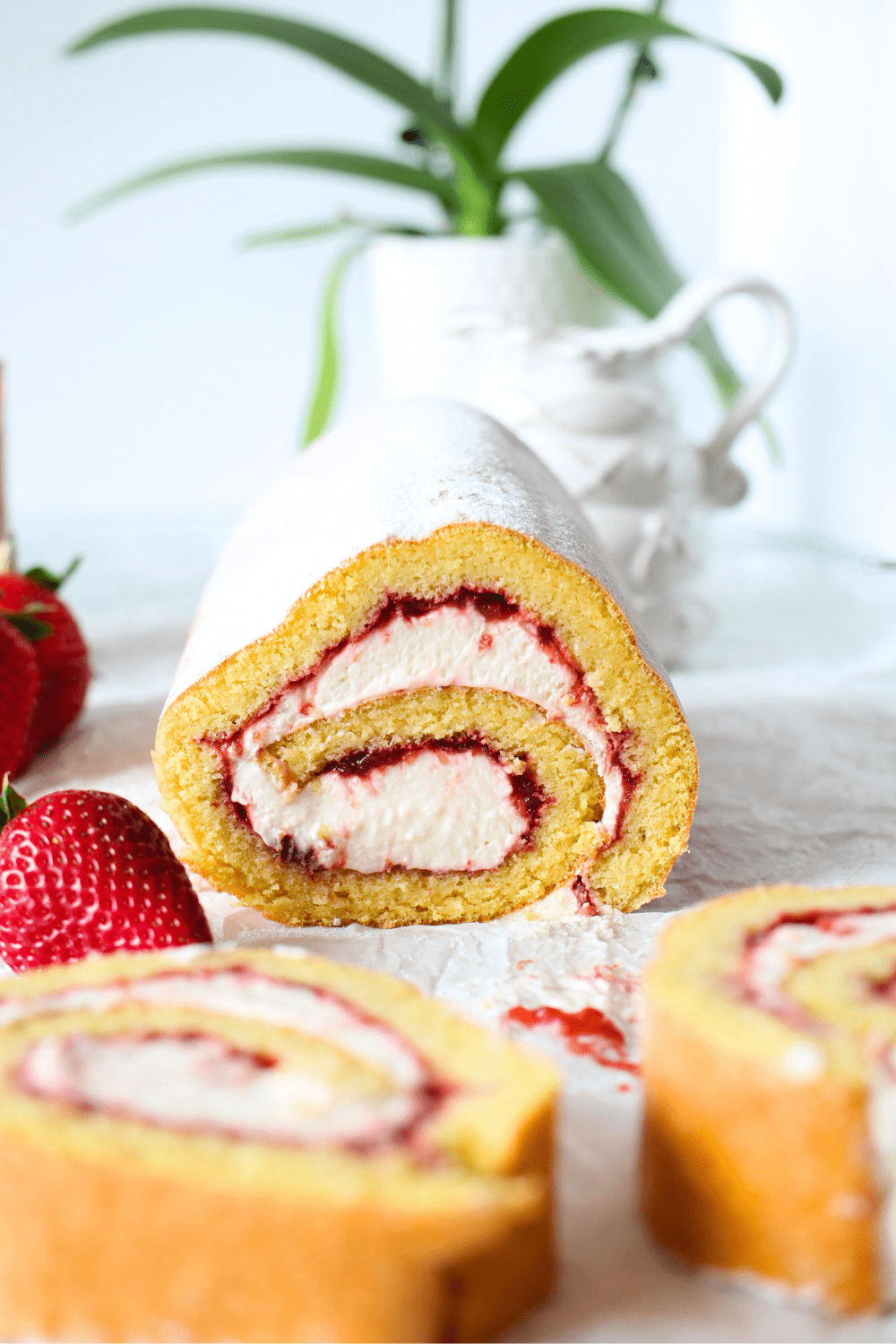 sugar-free strawberry cream dessert made into a keto roll cake
