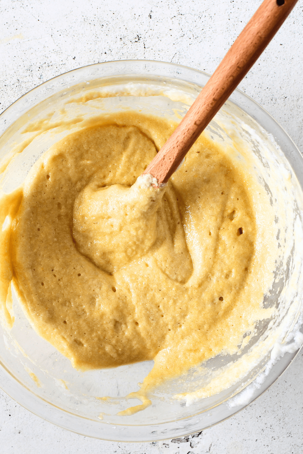 top view of bowl of keto upside-down cake batter with a spoon