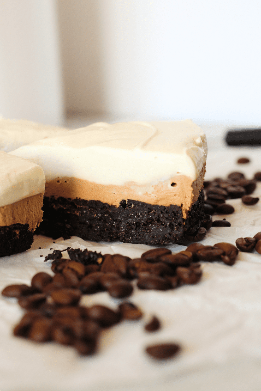 keto layered cake with a brownie layer, a mocha mousse and a vanilla topping