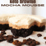 a slice of keto mocha layered cake with espresso beans scattered around