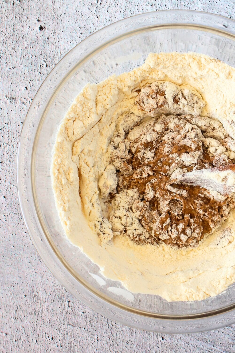 mixing bowl with low carb apple recipe ingredients including unsweetened apple sauce, protein powder and sunflower seed butter