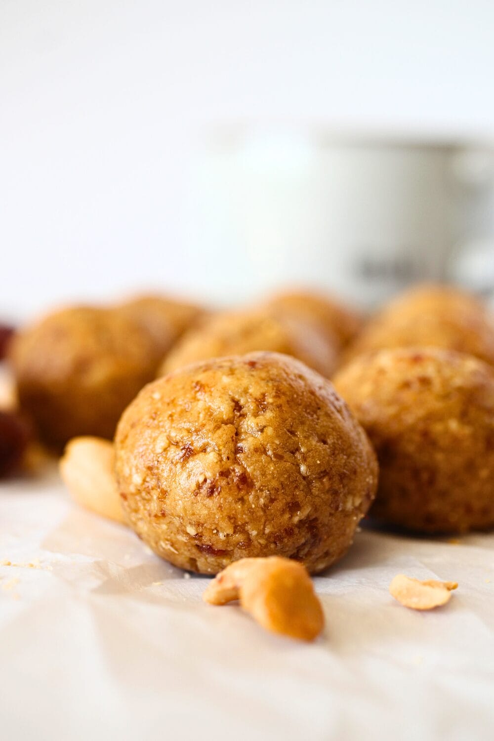 front view of a protein-packed cashew cookie bitew with scattered cashews and dates