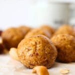 front view of a protein-packed cashew cookie bitew with scattered cashews and dates