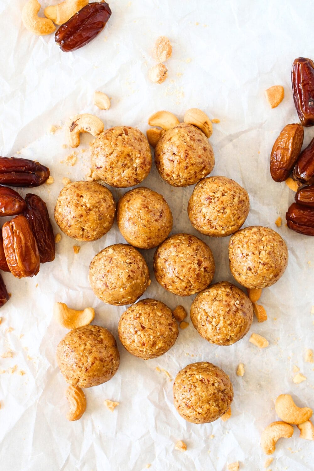 top view of healthy cashew bites with dates and cashews scattered about