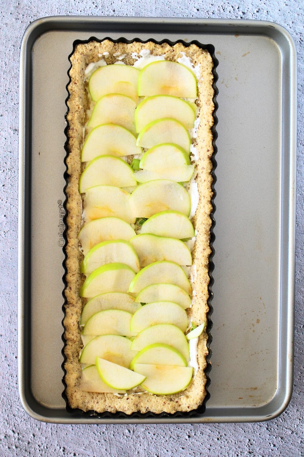 top view of keto apple tart with freshly sliced apples over the tart