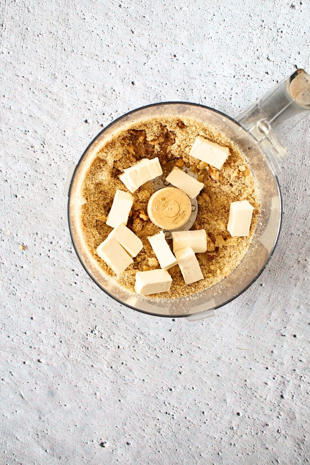 top view of a food processor with ingredients to make keto cookie cups