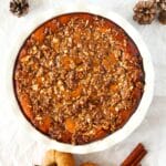 top view of healthy pumpkin crisp that is low carb and a sugar-free pumpkin recipe with decorative pumpkins to the side