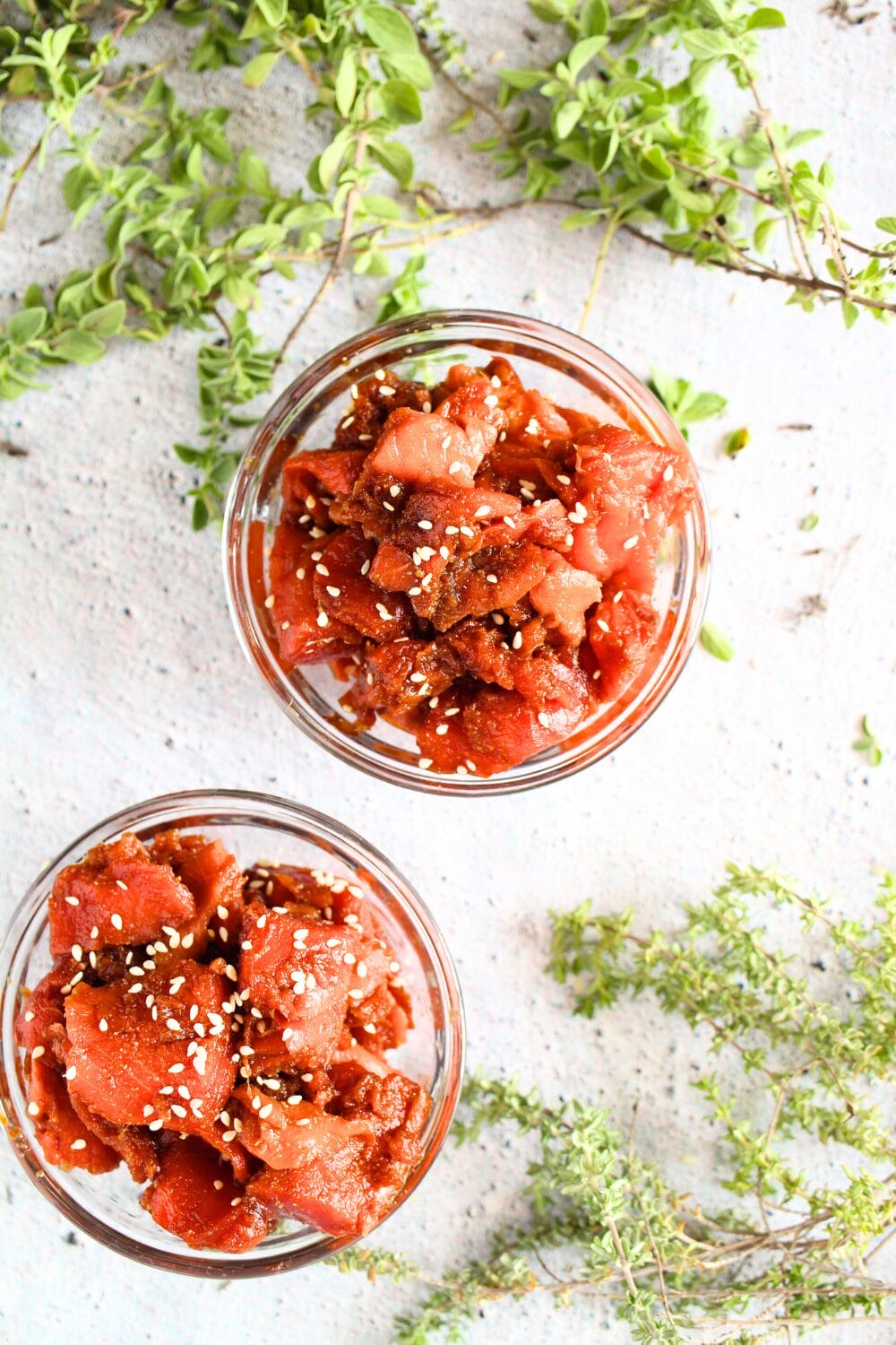 keto raw salmon in bowls for a zero carb recipe with fresh herbs as decorations