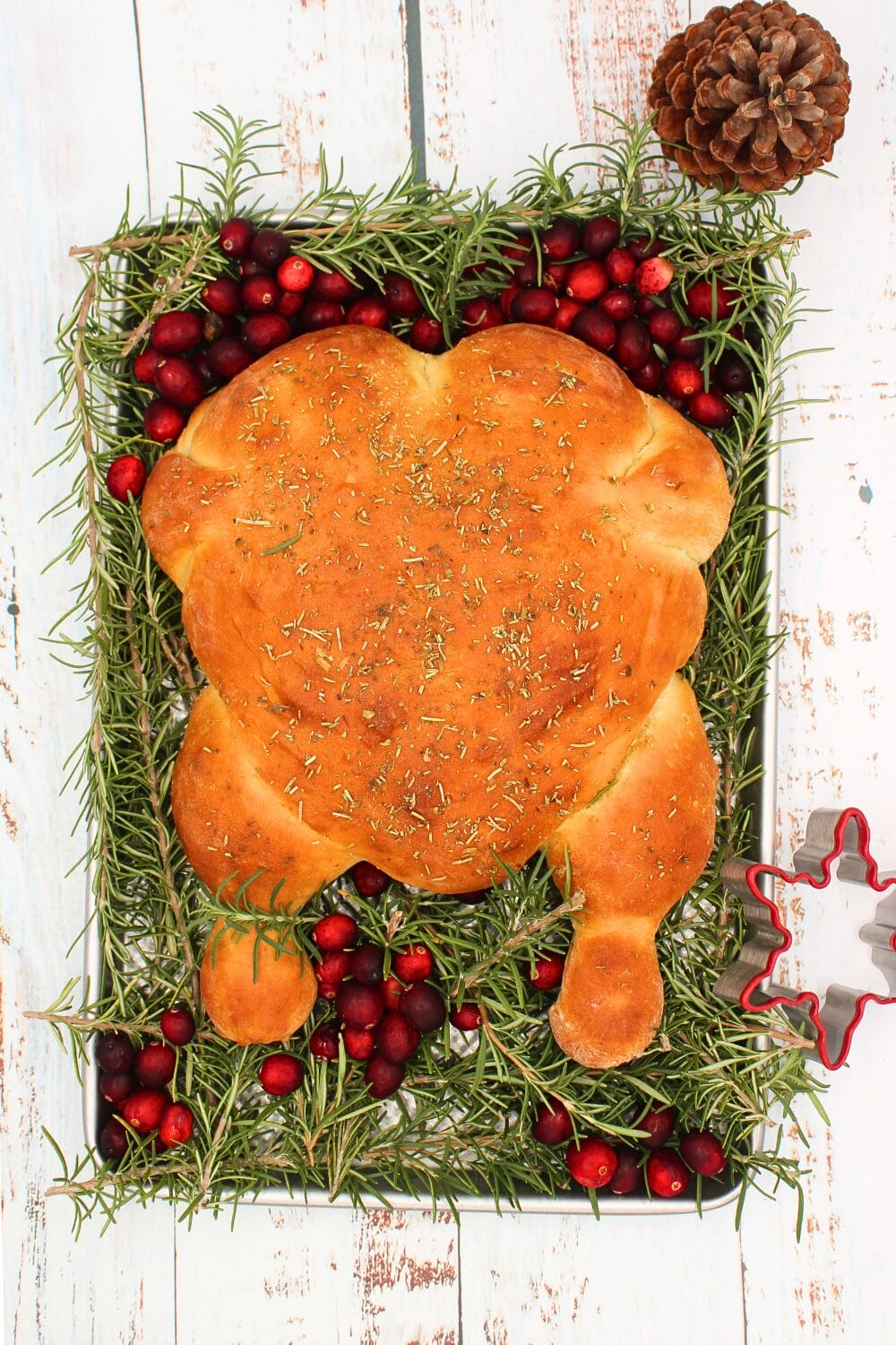 keto turkey bread on a serving platter with rosemary and cranberries