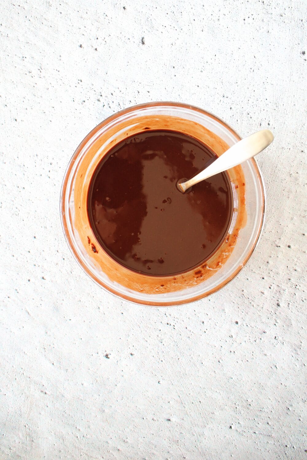 bowl with melted sugar-free chocolate for making keto pudding cake