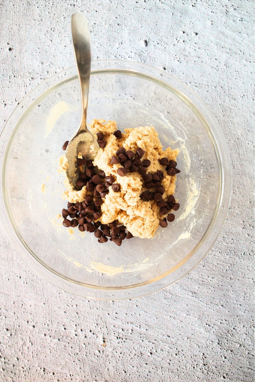 top view of protein-sparing modified fasting cookie dough with sugar-free chocolate chips being folded into the dough