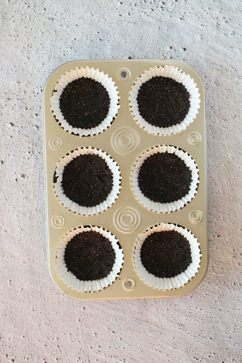 keto mocha cheesecake crusts in a muffin tin