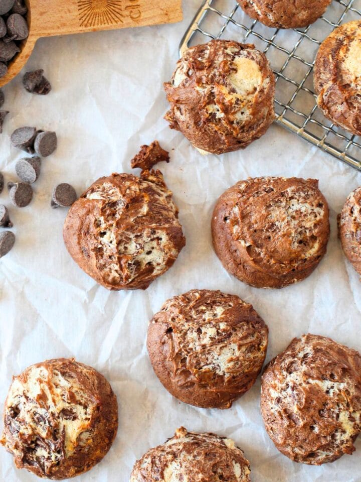 top view of high protein chocolate souffle cookies with sugar-free chocolate chips scattered around sugar-free cookies