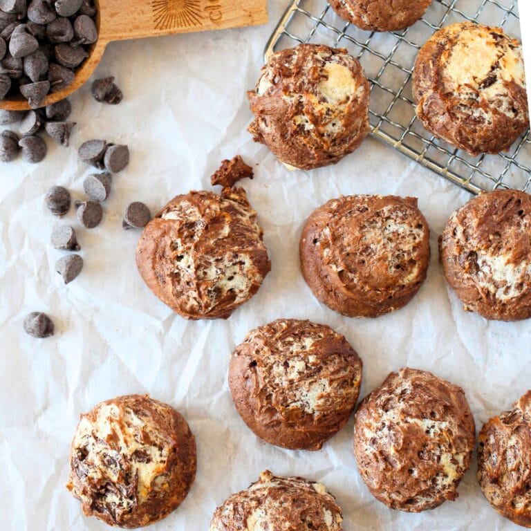 top view of high protein chocolate souffle cookies with sugar-free chocolate chips scattered around sugar-free cookies