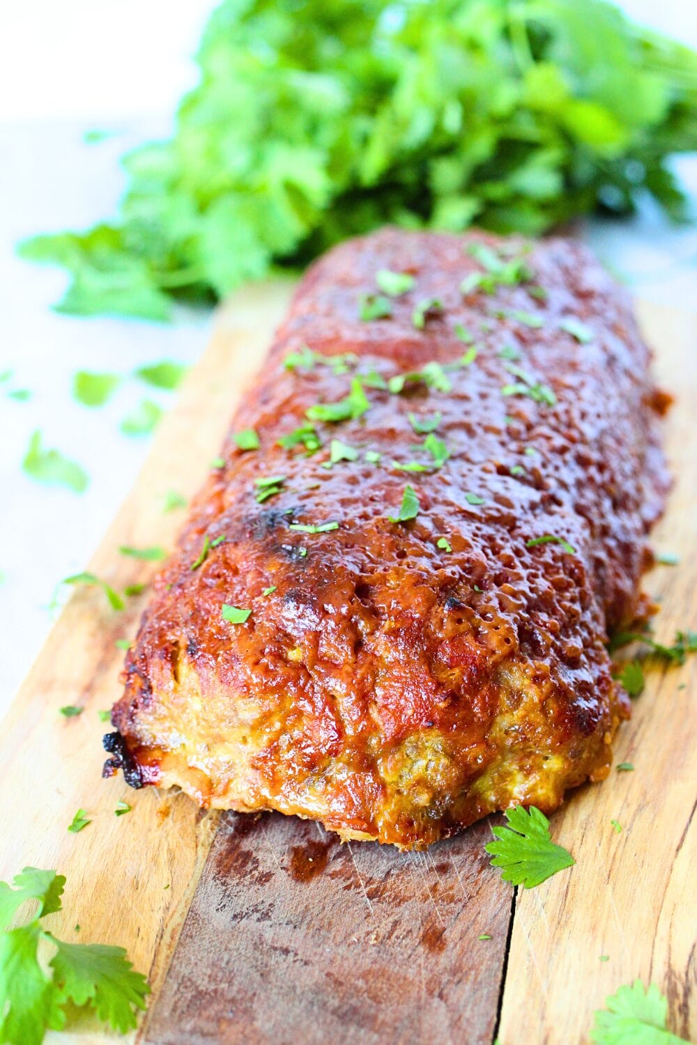 top view of leftover ham recipe made into a ham meatloaf with fresh herbs sprinkled over the keto ham loaf