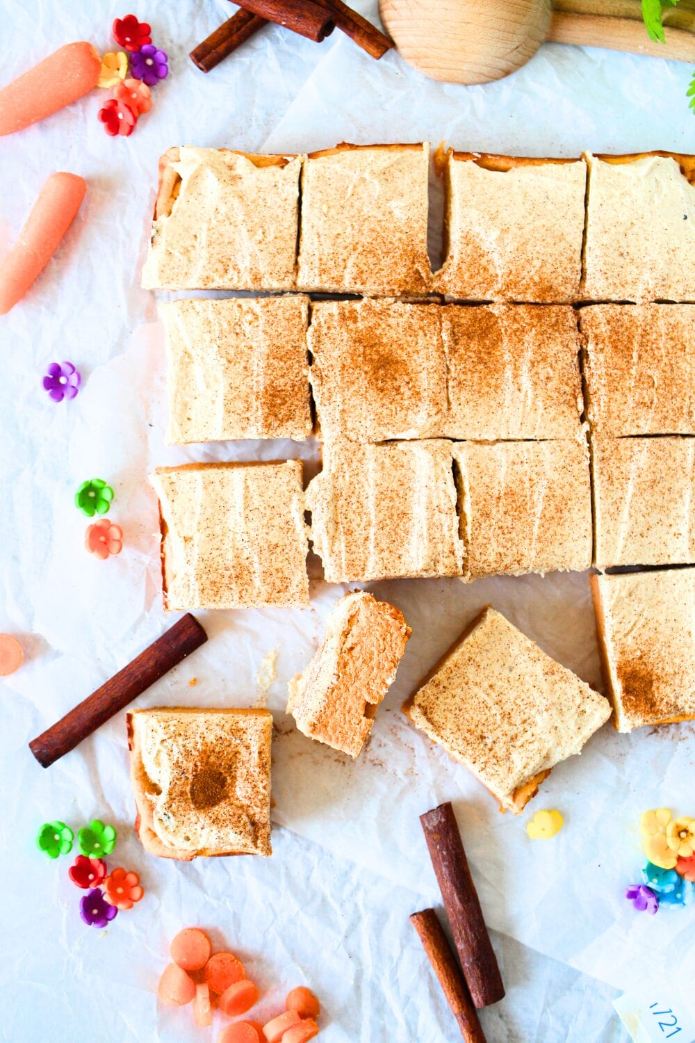 top view of carrot cake protein bars with protein frosting and a dusting of cinnamon