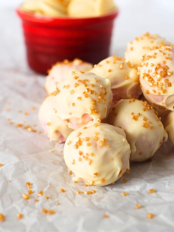 stack of high protein bites made with sugar-free white chocolate, casein protein powder and unsweetened coconut shreds.