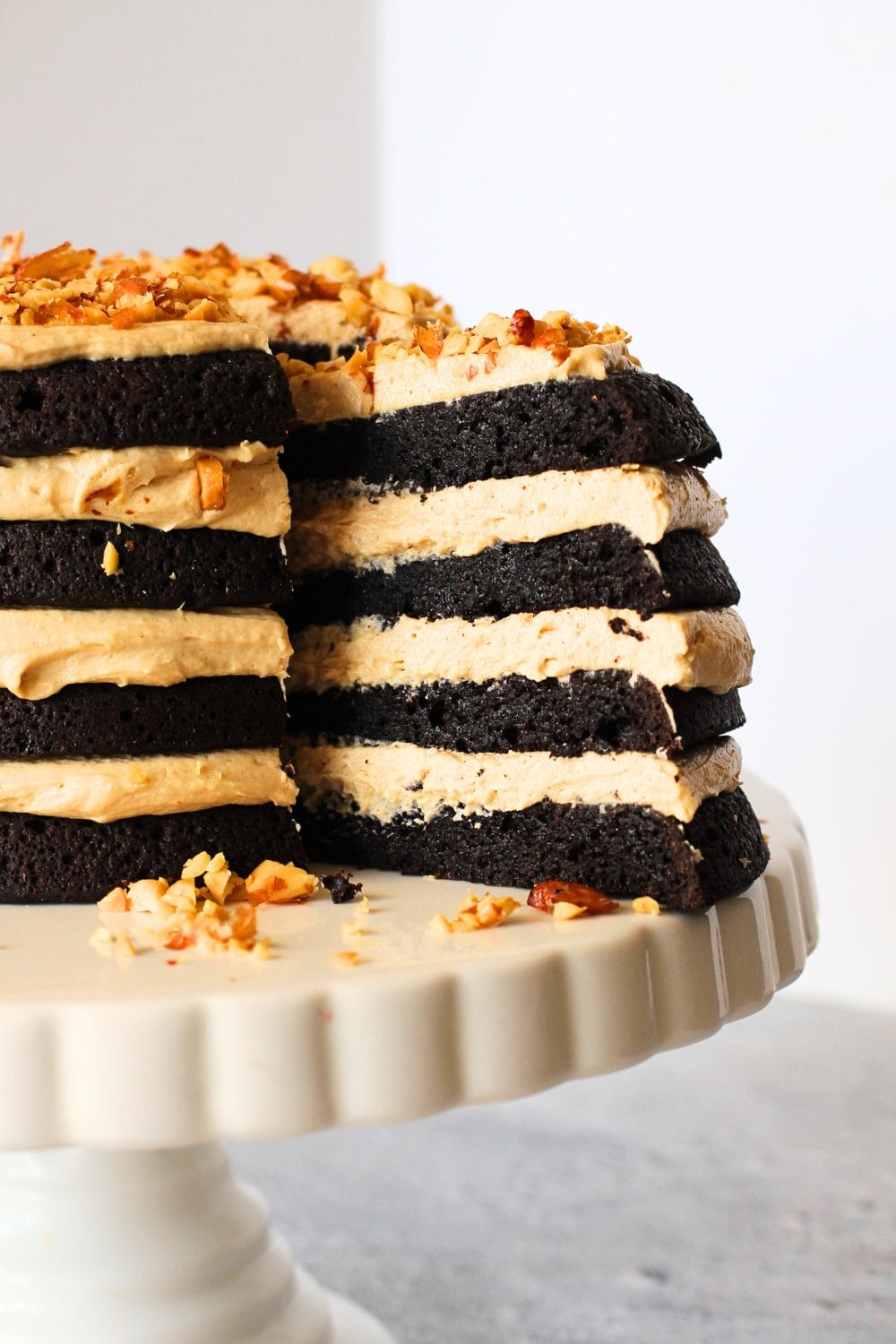 sugar-free chocolate cake  recipe with layers of keto peanut butter frosting on a cake plate