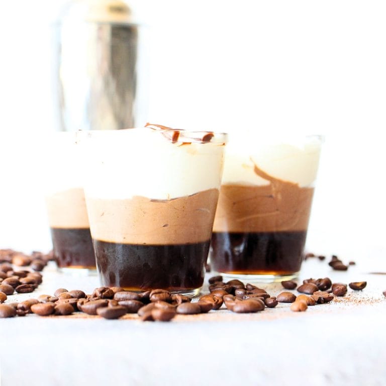 front view of 4 keto chocolate espresso mousse martini desserts with scattered espresso beans