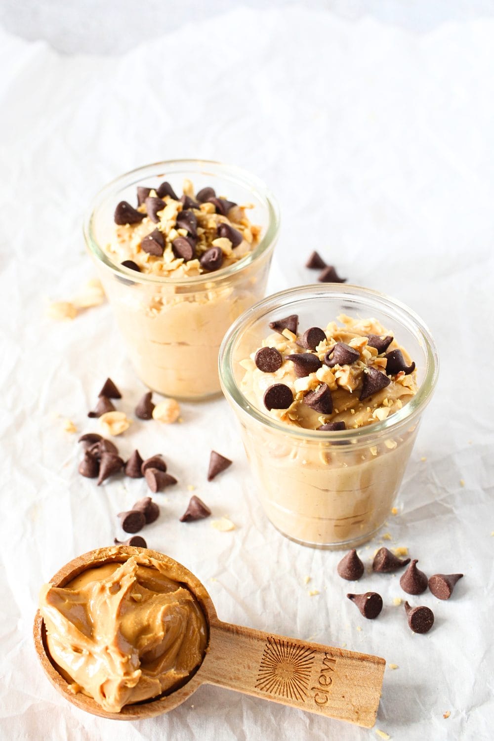 2 glasses filled with high protein peanut butter mousse topped with sugar-free chocolate chips