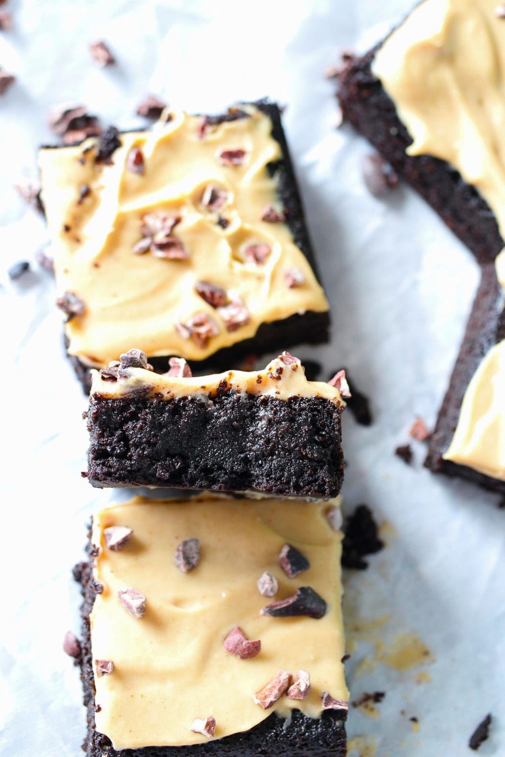 top view of keto vegan brownie recipe with peanut butter frosting and cocoa nibs