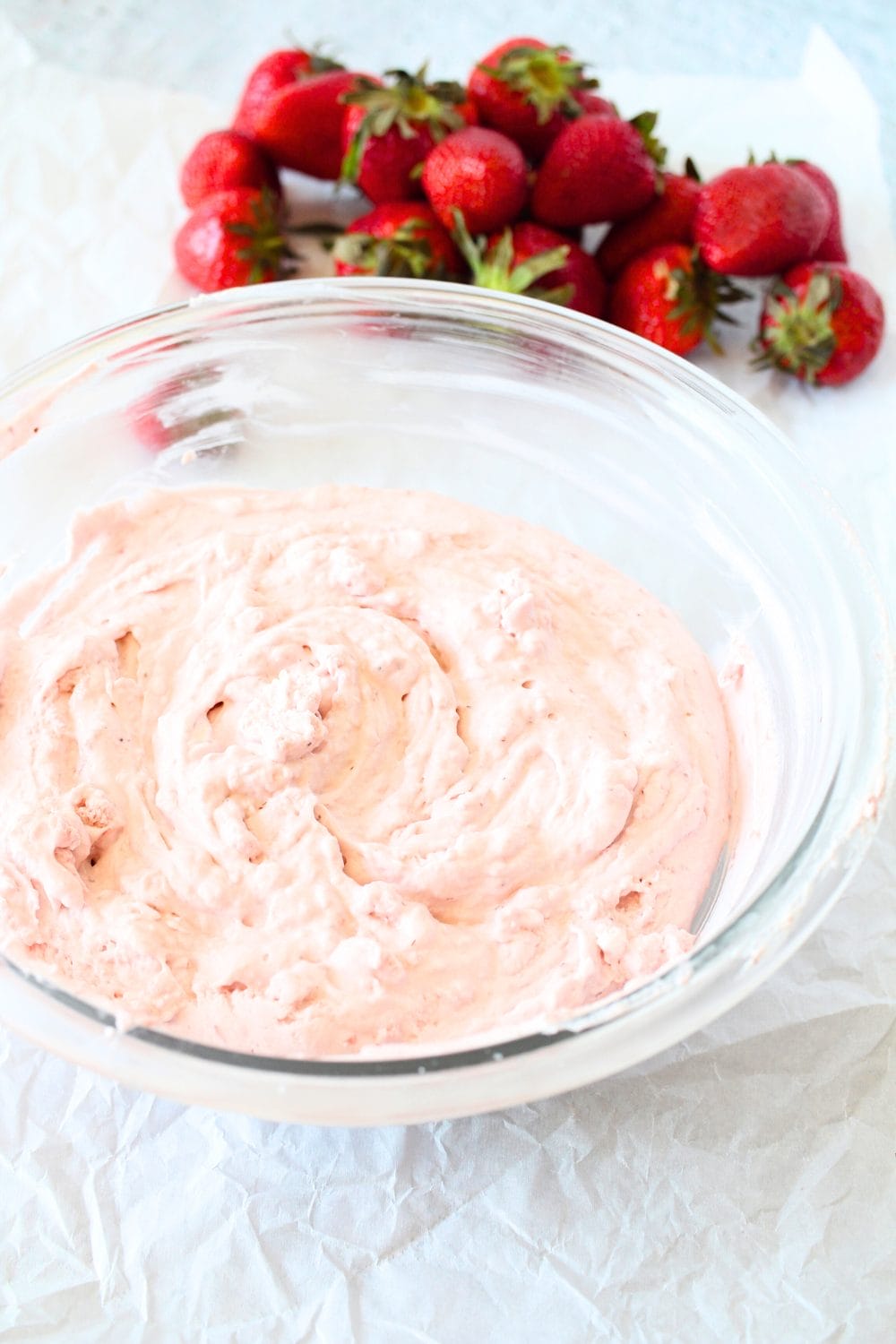 a bowl filled with keto strawberry frosting that only requires 4 ingredients