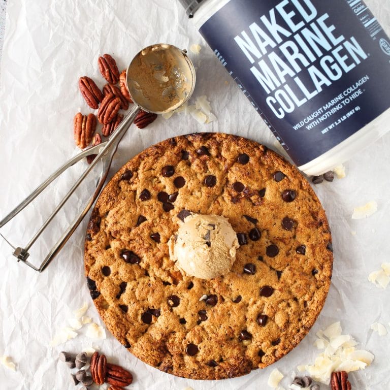 top view of keto collagen cookie with a tub of naked marine collagen and a cookie scoop