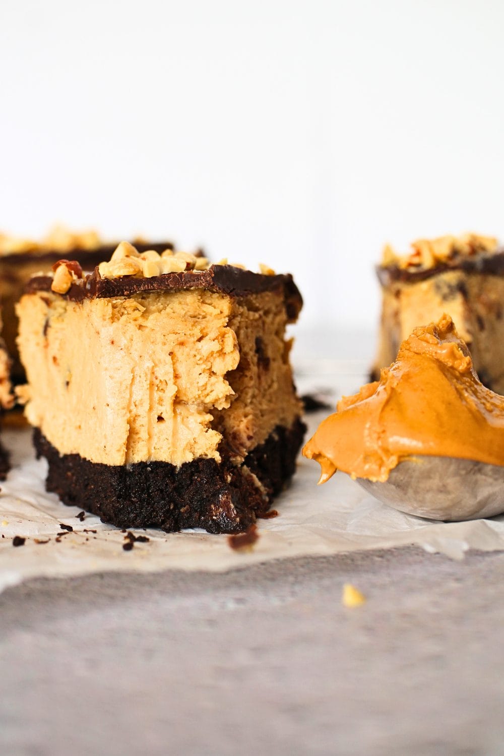 front view of a slice of keto peanut butter chocolate cheesecake 