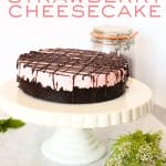 front view of no-bake keto strawberry cheesecake with chocolate drizzle on a serving platter